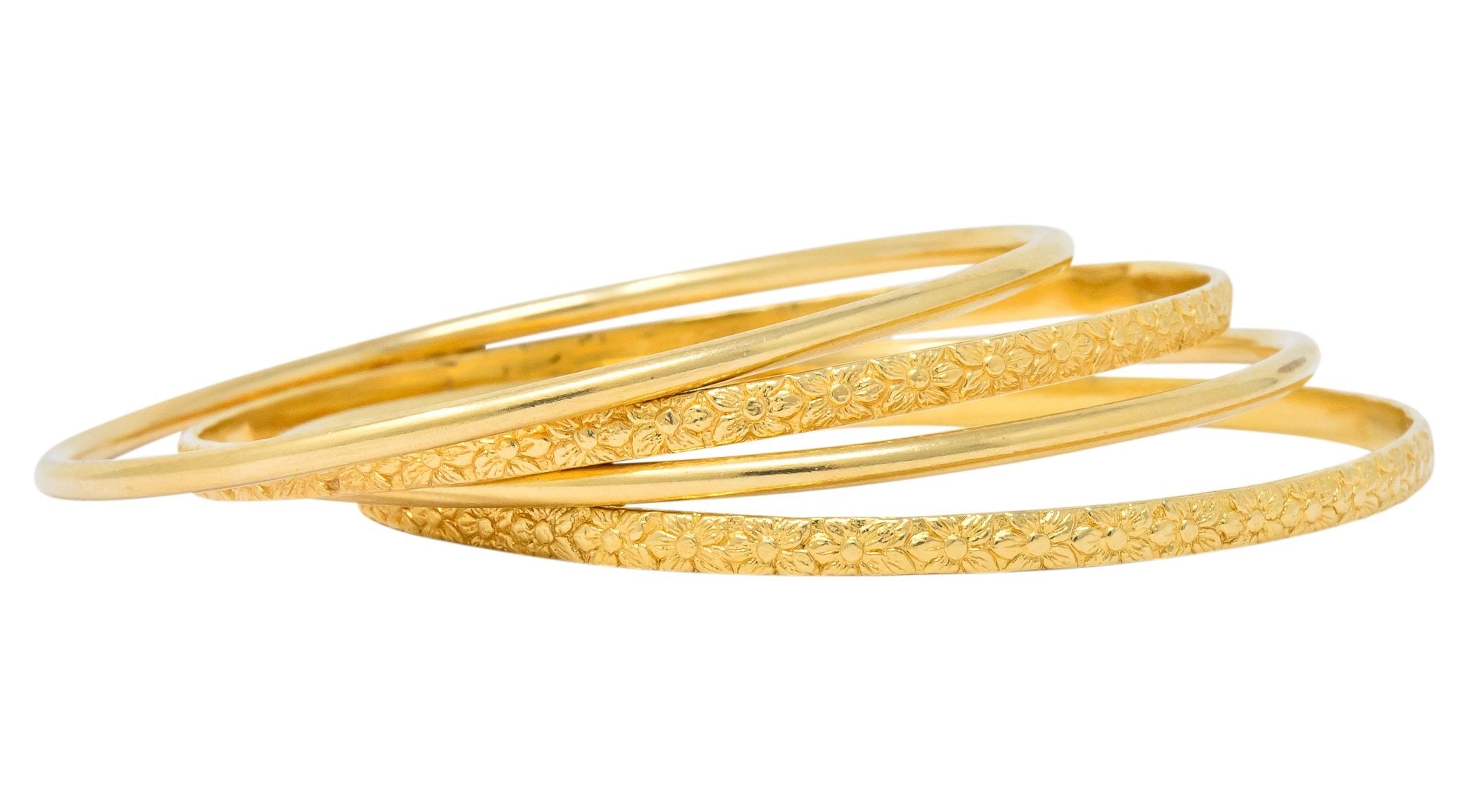 Four Vintage 14 Karat Yellow Gold Decorated Bangle Bracelets - Wilson's Estate Jewelry