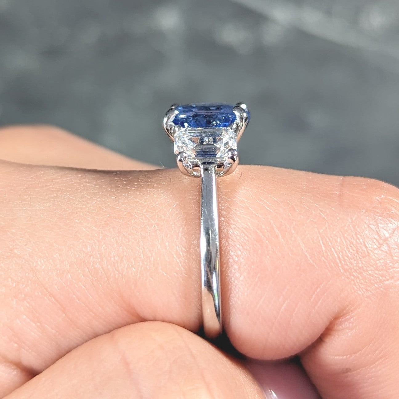 Contemporary 4.82 CTW Oval Cut No Heat Sapphire Emerald Cut Diamond Platinum Three Stone Ring GIA Wilson's Estate Jewelry