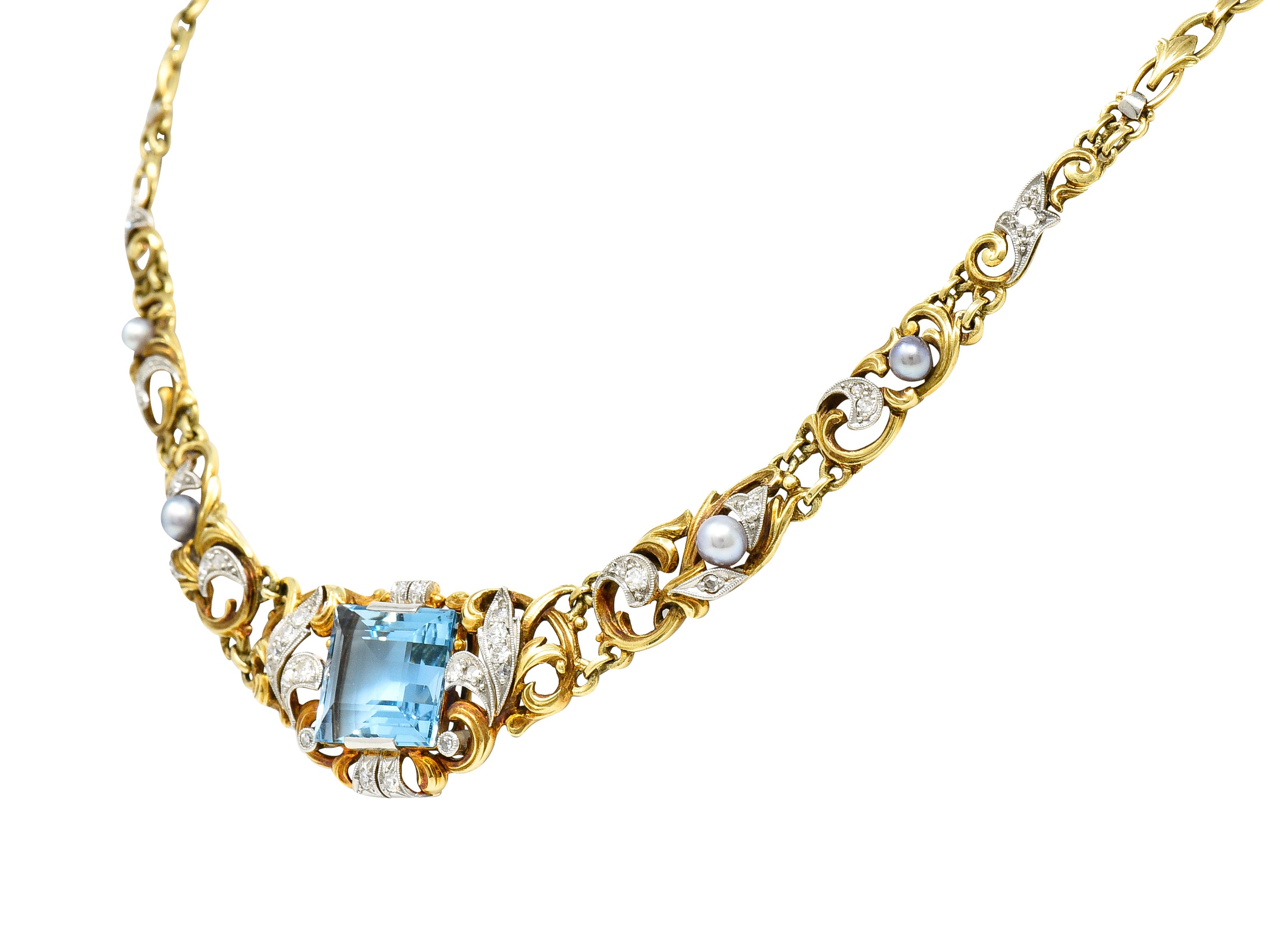 Edwardian 9.71 CTW Step-Cut Aquamarine Diamond Pearl Platinum 14 Karat Yellow Gold Fleur-De-Lis Antique Station Necklace Wilson's Estate Jewelry